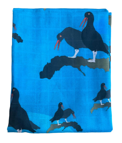 Oyster catcher dish towel with blue background and back comical birds
