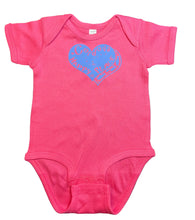 Pink baby onesie with a blue Cordova is my Happy Place heart design on a dark surface